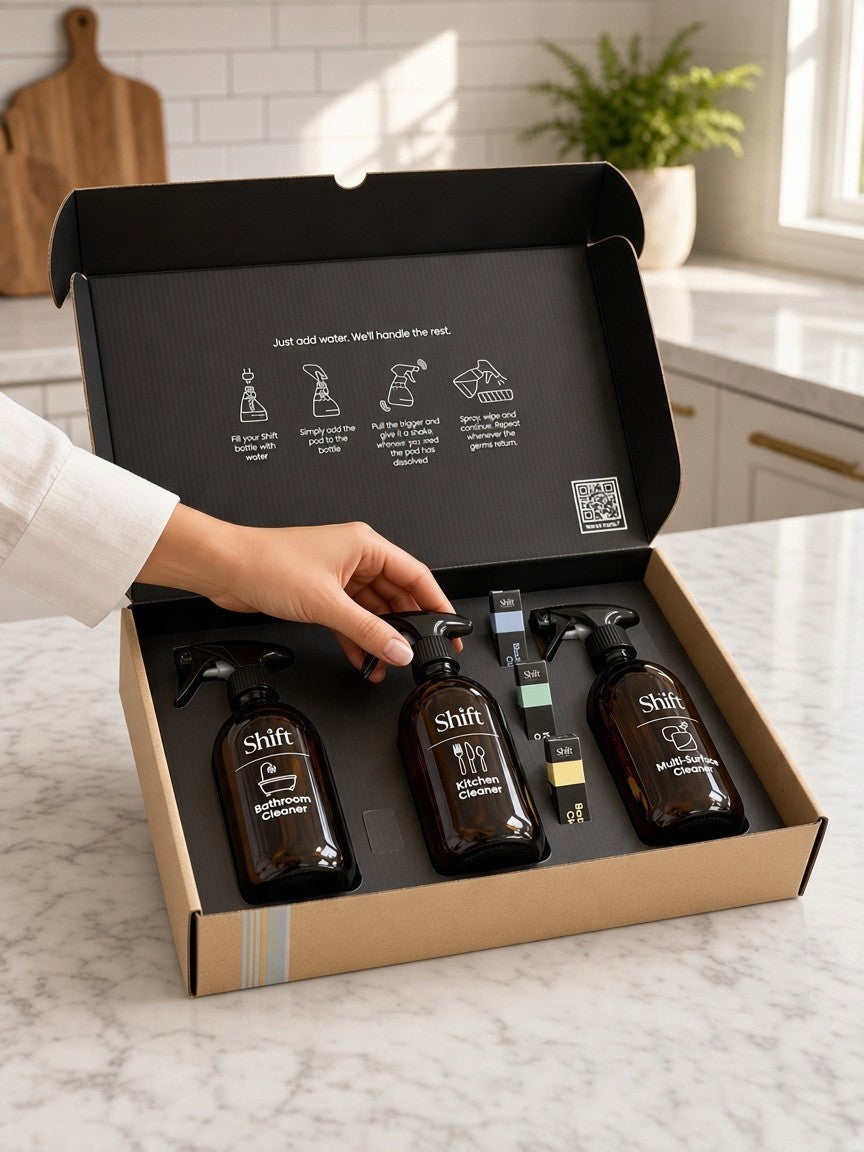 Shift The Full Shift cleaning kit featuring three amber glass spray bottles and refill pods in a cardboard box